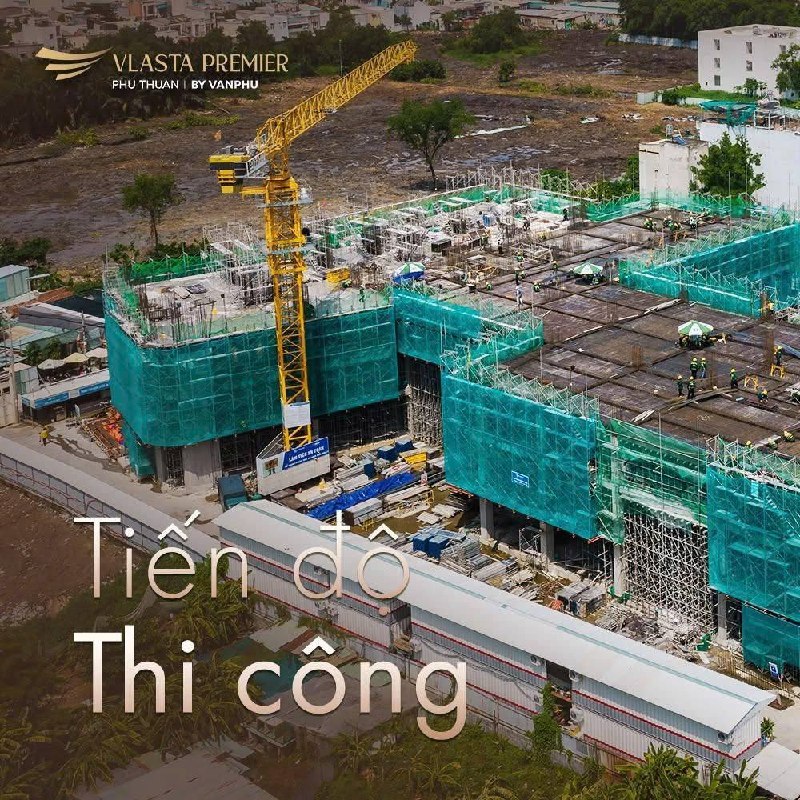 Toàn cảnh công trường Vlasta Premier Phú Thuận nhìn từ trên cao với cẩu tháp và lưới an toàn xanh